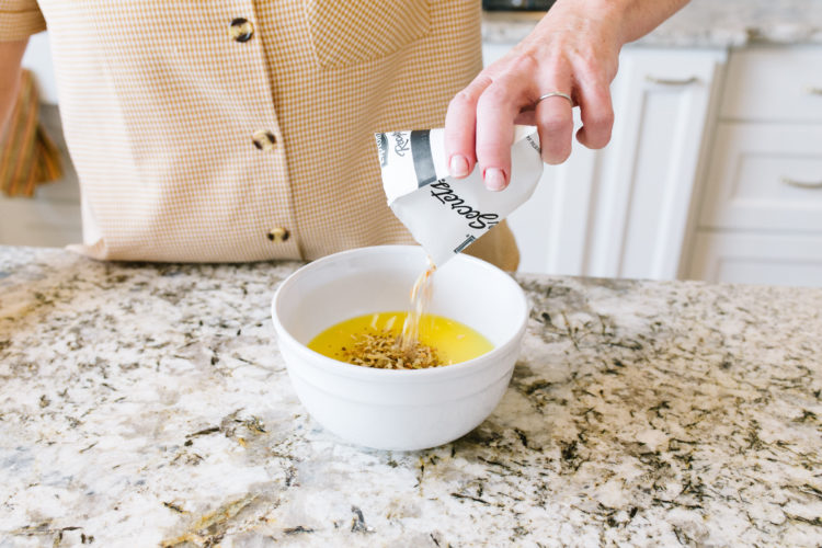 Envelope with Lipton onions being poured in a bowl with melted butterof Lipton Onion Potatoes