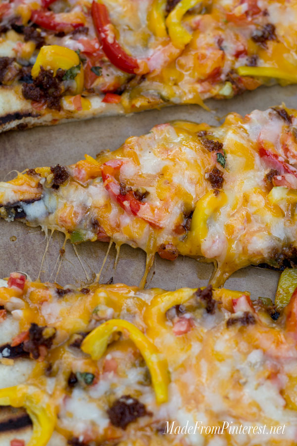 Grilled Flat Bread with Chorizo and Peppers - If you have never made bread on the BBQ you have been missing out! You can make this flat bread with refrigerated pizza dough and be done start to finish in 15 minutes. The BBQ gives this bread the perfect combination of flavors.