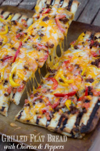 Grilled Flat Bread with Chorizo and Peppers - If you have never made bread on the BBQ you have been missing out! You can make this flat bread with refrigerated pizza dough and be done start to finish in 15 minutes. The BBQ gives this bread the perfect combination of flavors.