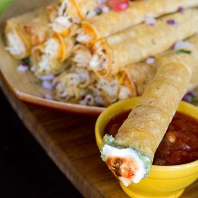 Crockpot Cream Cheese Taquitos - Use your crockpot to make this moist flavorful creamy chicken. Fill flour or corn tortillas with cream cheese chicken and cheese, bake and enjoy! These are fantastic!