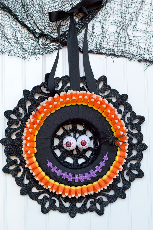 I love making Halloween decorations! This monster candy corn wreath is fun, easy and inexpensive with supplies from Dollar Trees Value Seekers Club. #DTVSC #AD