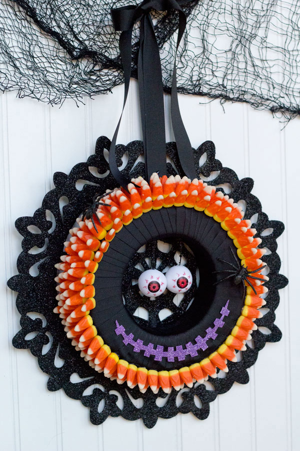 I love making Halloween decorations! This monster candy corn wreath is fun, easy and inexpensive with supplies from Dollar Trees Value Seekers Club. #DTVSC #AD