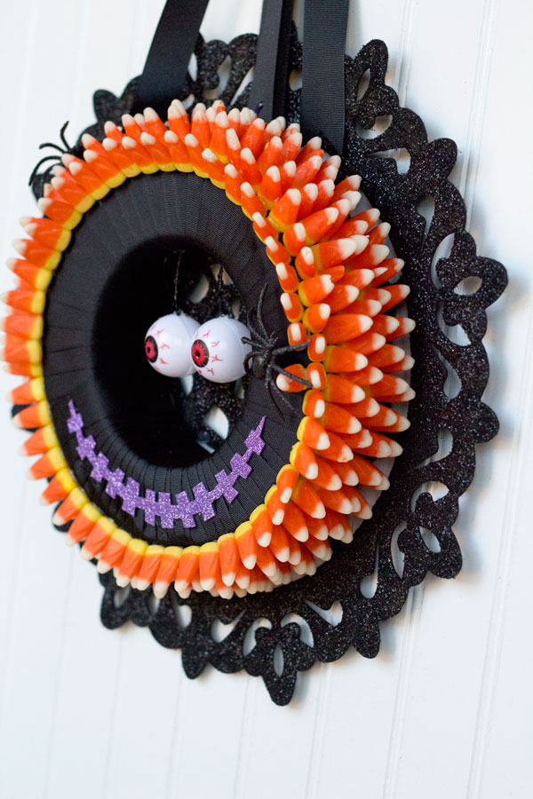 I love making Halloween decorations! This monster candy corn wreath is fun, easy and inexpensive with supplies from Dollar Trees Value Seekers Club. #DTVSC #AD