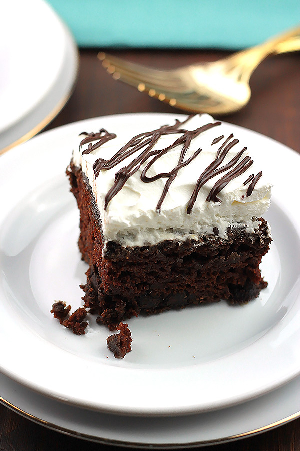 Coconut Cream Chocolate Cake - This cake is rich, moist and full of flavor. The chocolate cake is frosted in a light and fluffy creamy coconut milk frosting making it irresistible! 