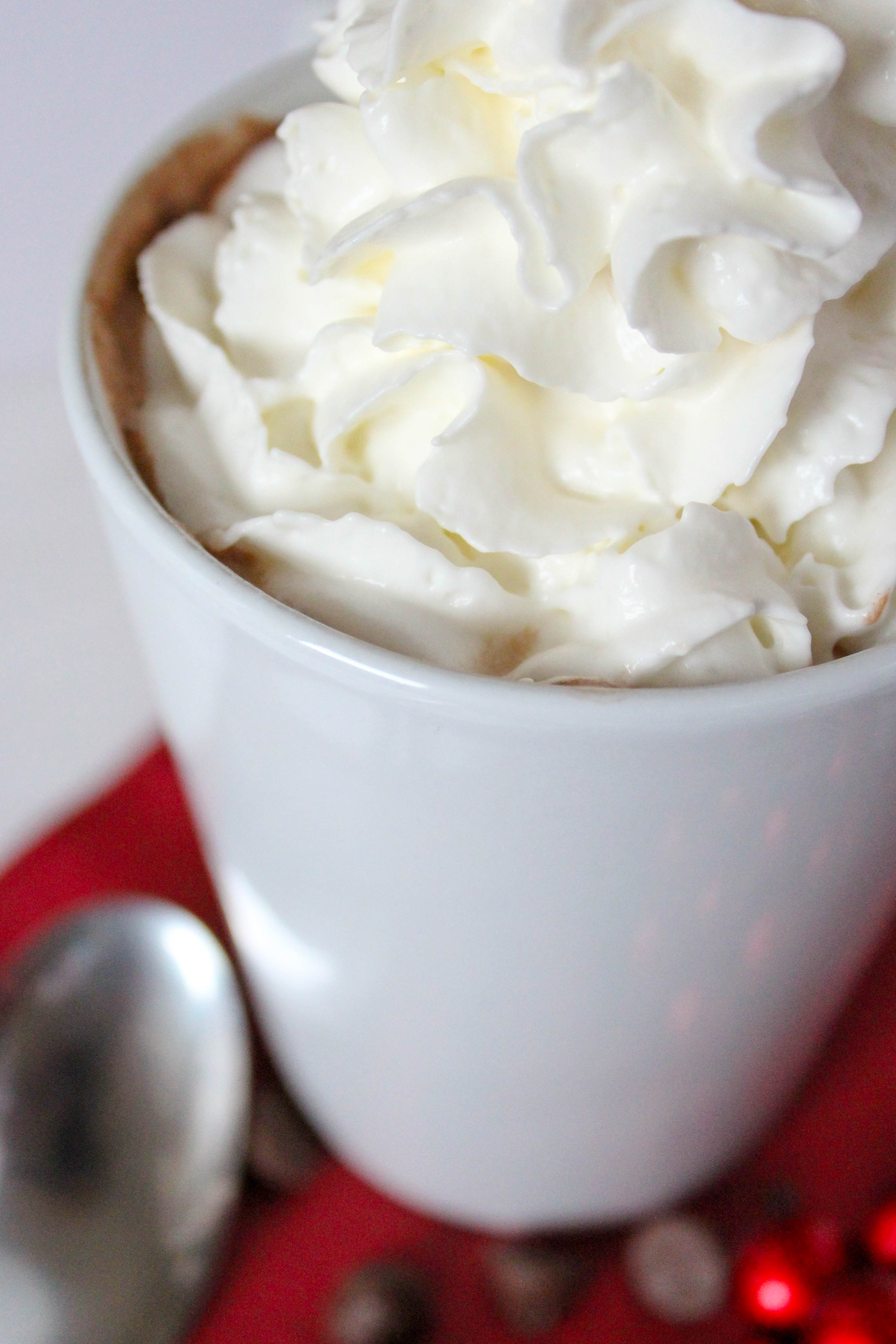 Amaretto Hot Chocolate- smooth and creamy hot chocolate with only 6 ingredients! Add everything to the crock pot for two hours and enjoy a rich and creamy drink to sip on this christmas. 