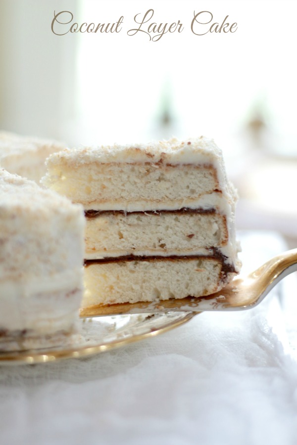 A Coconut Layer Cake with three layers separated by a schmear of Nutella and coconut cream cheese frosting. A perfect Easter dessert!