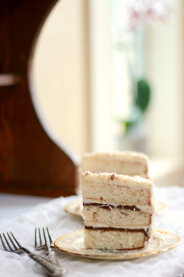 Coconut cake is 3 layers high and has Nutella in the filling - It's an over the top family favorite!! From MadeFromPinterest.net