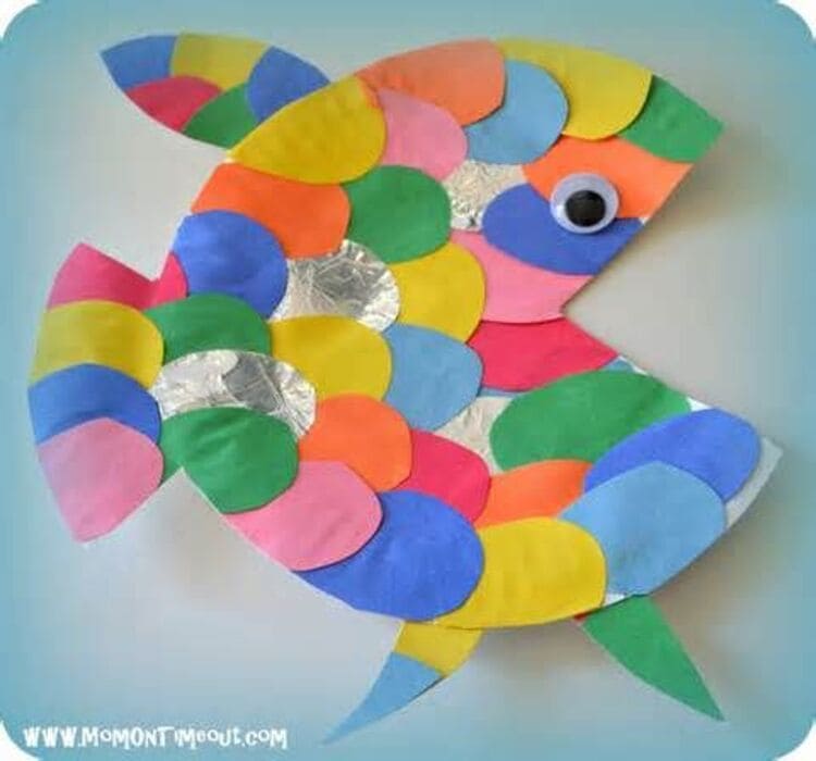 paper plate craft rainbow fish with yellow, green, pink, red, blue scales, on a white background