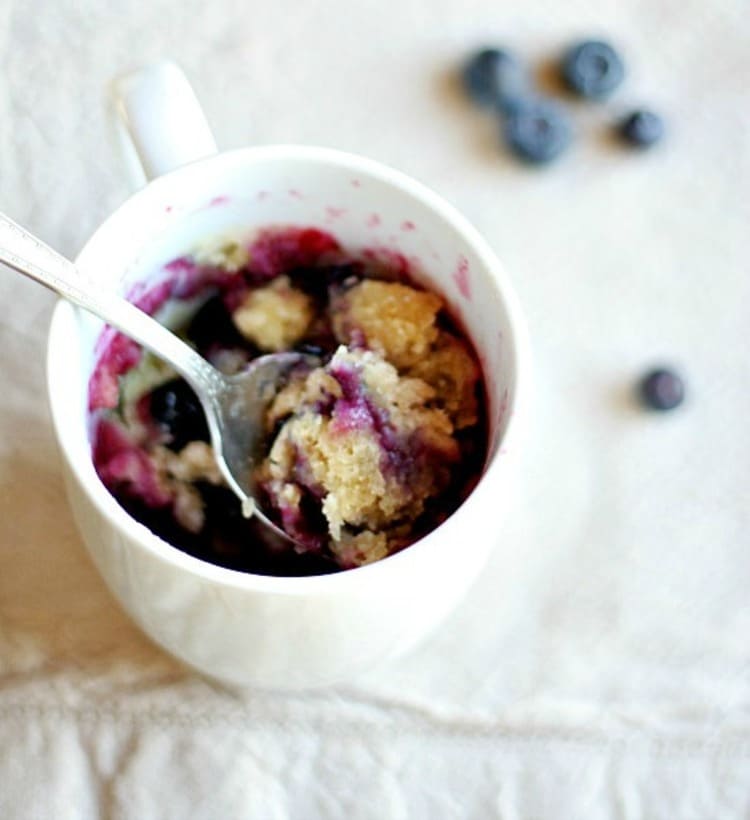 microwave mug snacks blueberry muffin in a white cup with s spoon in it