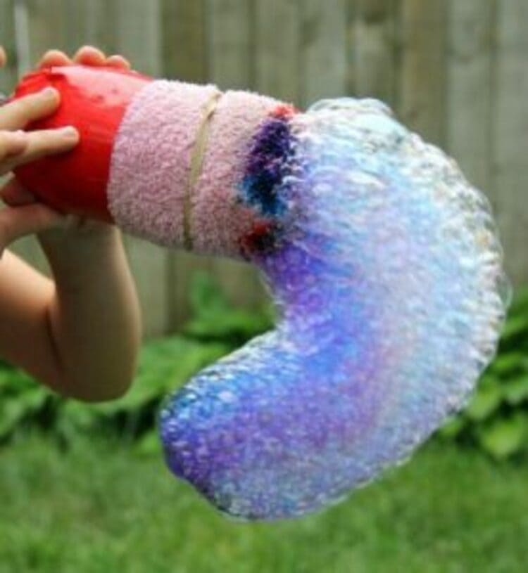 science project bubble snakes colored in blue and hands holding it