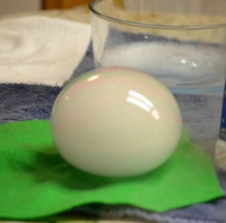 science project dry ice bubble on a green napkin in front of a transparent glass