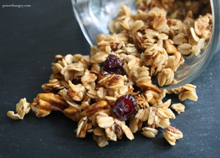 microwave mug snacks granola in a transparent cup on a black flat surface