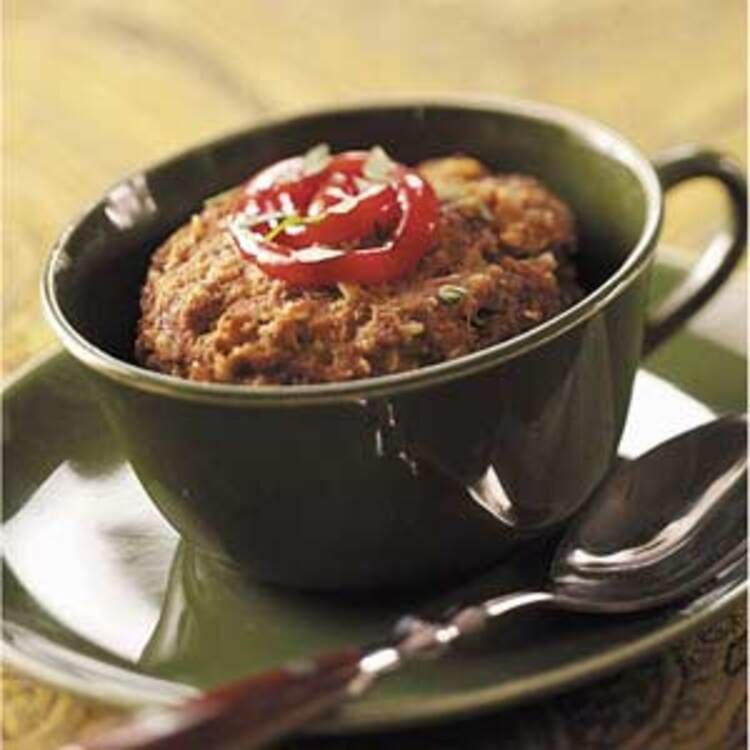 microwave mug snacks meatloaf in a black cup with a spoon next to it and ketchup on top