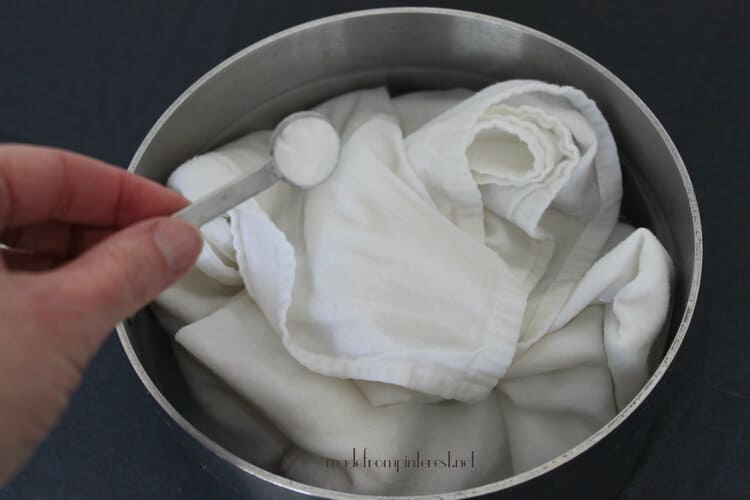 No Cracks, Easy Peel, Perfect Hard Boiled Eggs pot with cotton cloth inside and a hand holding a spoon with baking soda