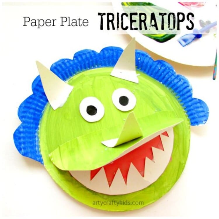 paper plate craft green triceratops with open mouth smiling, on a white background