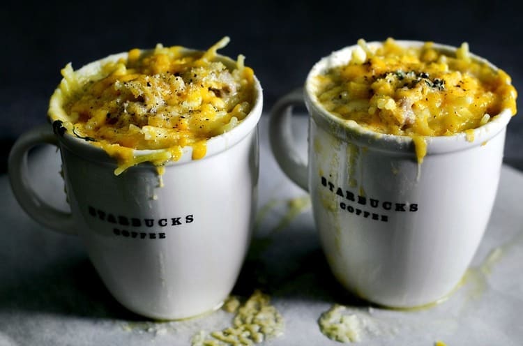 microwave mug snacks two white cups of spaghetti on white tabletop with starbucks coffee label on them