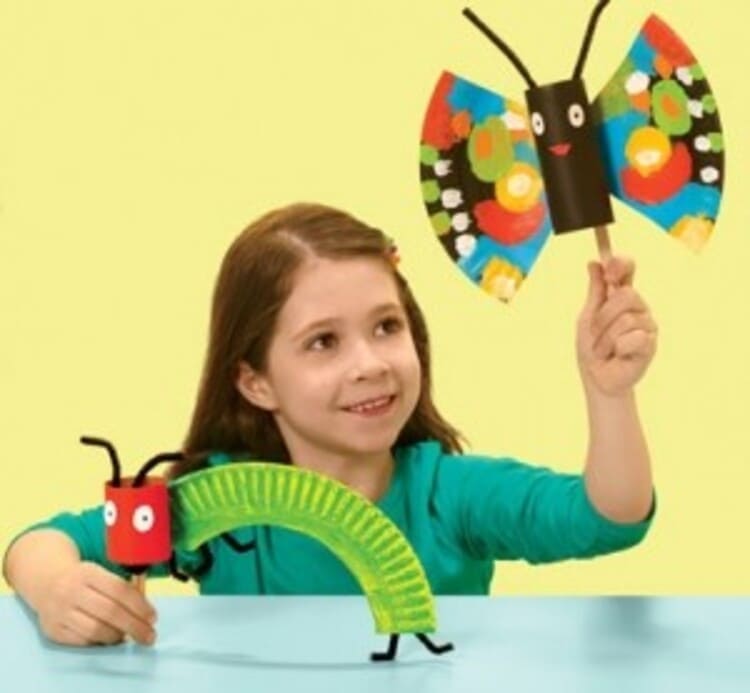 paper plate craft kid holding colorful paper plate butterfly and a caterpillar