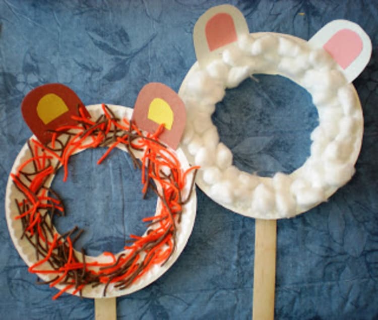 paper plate craft lion and lamb mask on a blue background