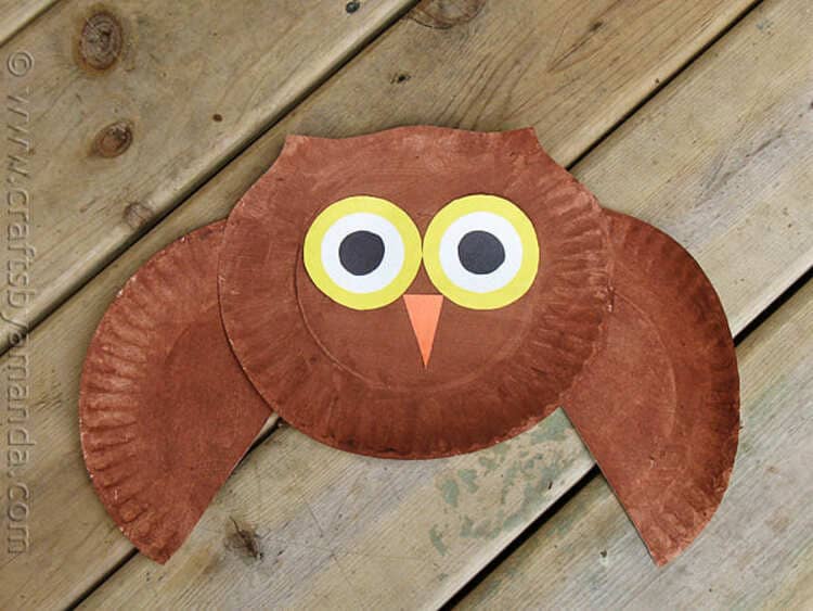 paper plate owl craft on a wooden background