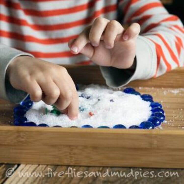 Epsom salts sensory play - A child playing with Epsom salts on a plate