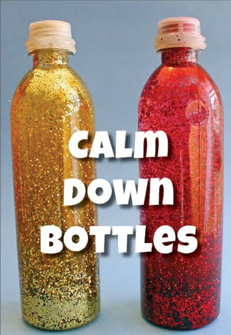 Two bottles filled with glitter placed on a table