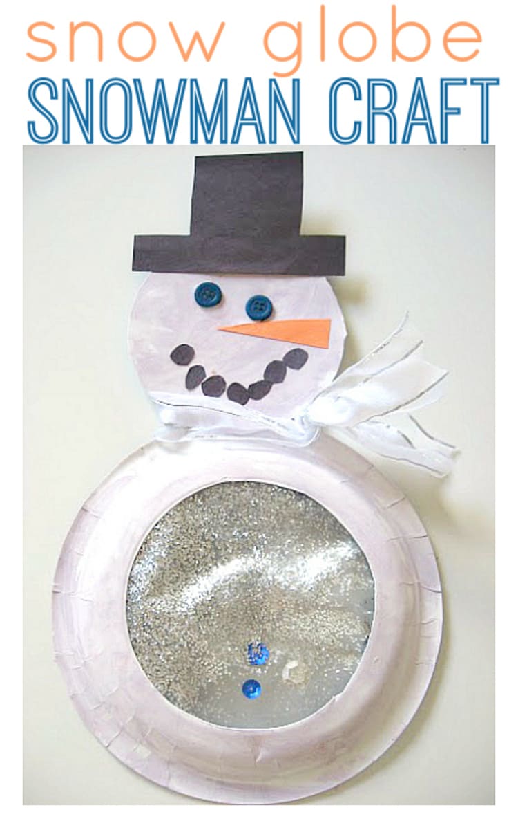 snow globe snowman craft with glitter and a white ribbon, wearing black hat on a white background