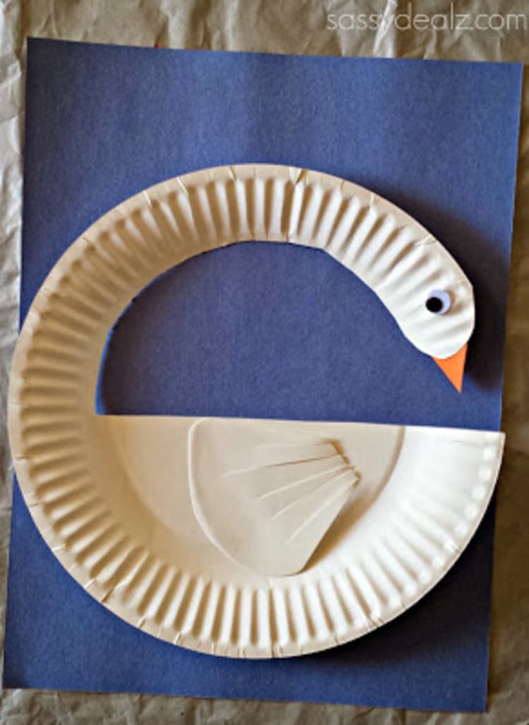 white paper plate swan on a blue background