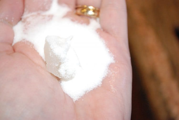 Chapped hand with baking soda sitting atop petroleum jelly