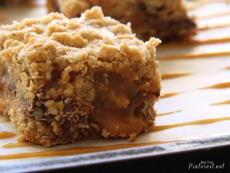 Carmelitas This Grandma Is Fun close up of a carmelitas cookie bar slice with another slice in the background, caramel drizzled on the plate (2)