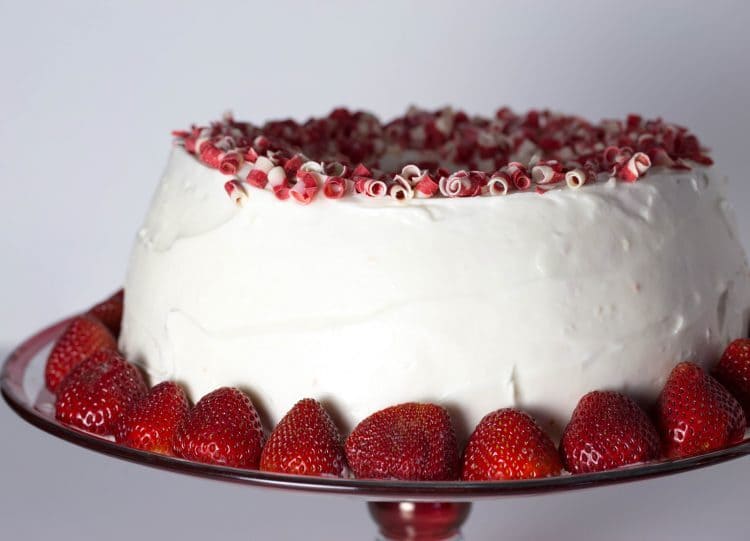 Full strawberry filled angel filled cake placed on a plate