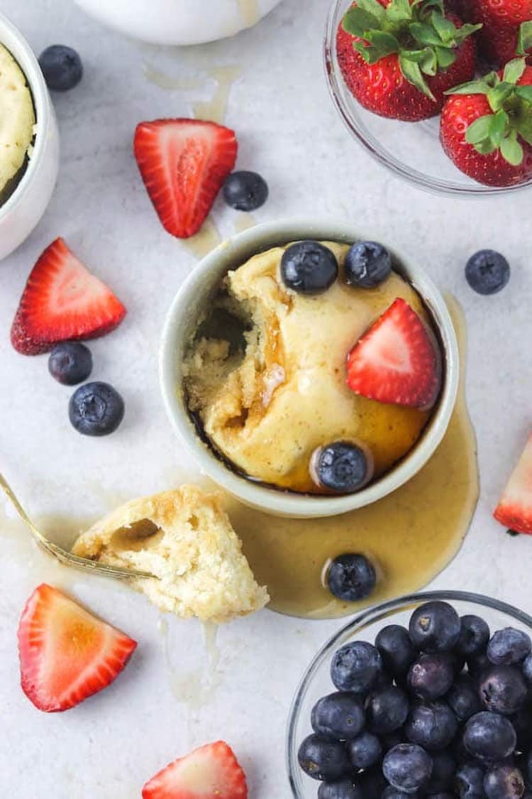 microwave mug snacks pancake in a white cup with strawberries and blueberries abound it