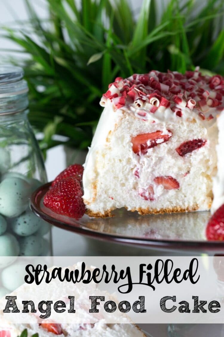 strawberry filled angel food cake cut in half and laid on a plate