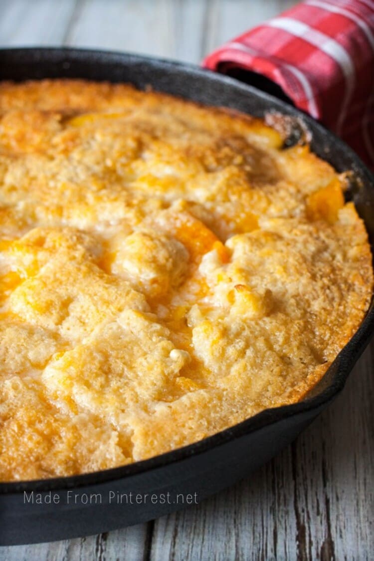 crusty looking two-two peach cobbler in a baking pan ready to be served