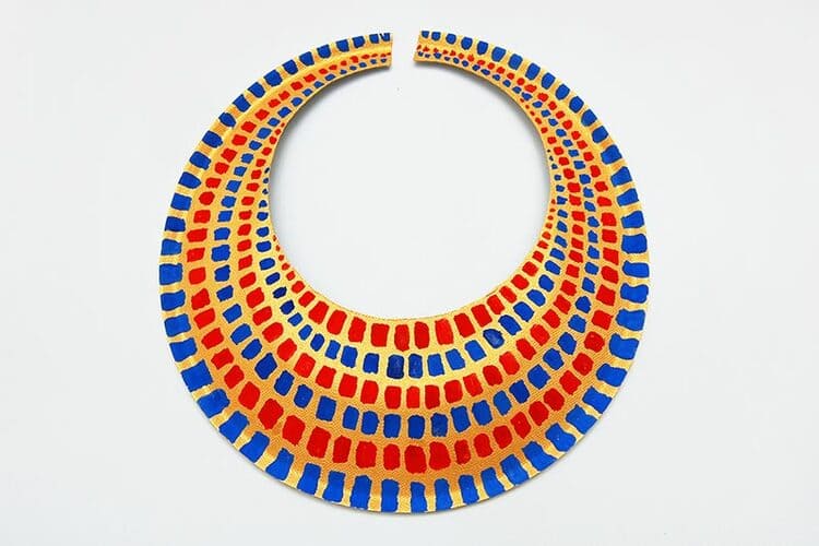 paper plate craft eqyptian necklace with red and blue colors on a white background