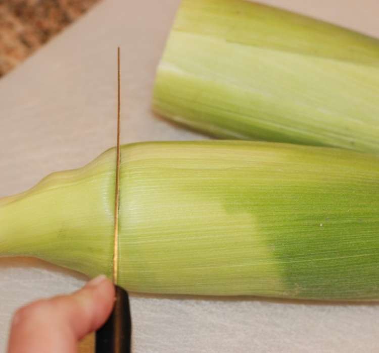 Cutting the stalk off corn on the cob
