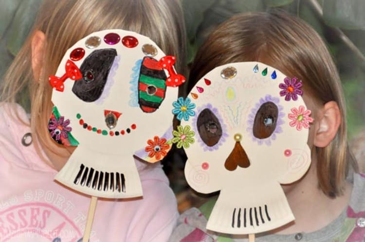 paper plate craft skull masks wearing by two kids