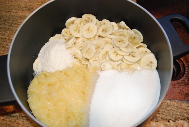 photo of pan containing sliced banana, crushed pineapple, grounded coconut and sugar